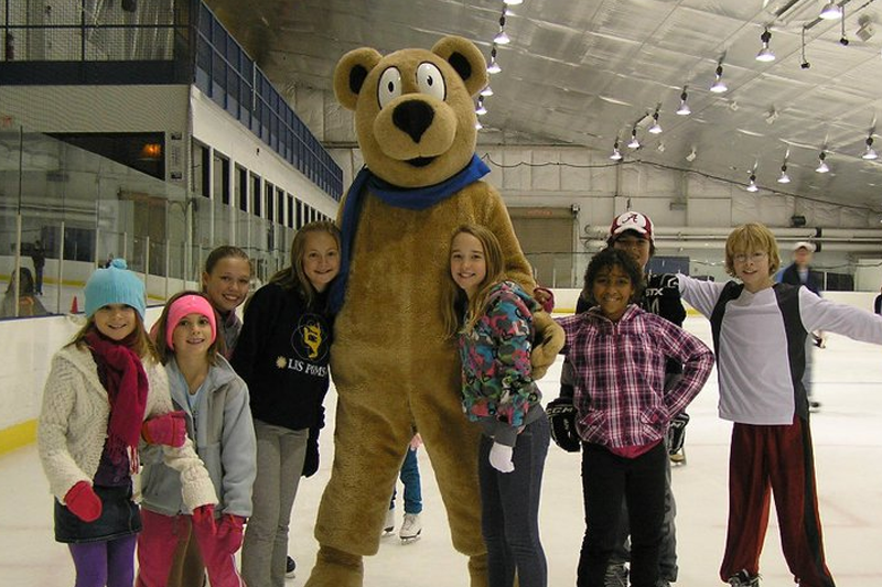kids skating with giant bear
